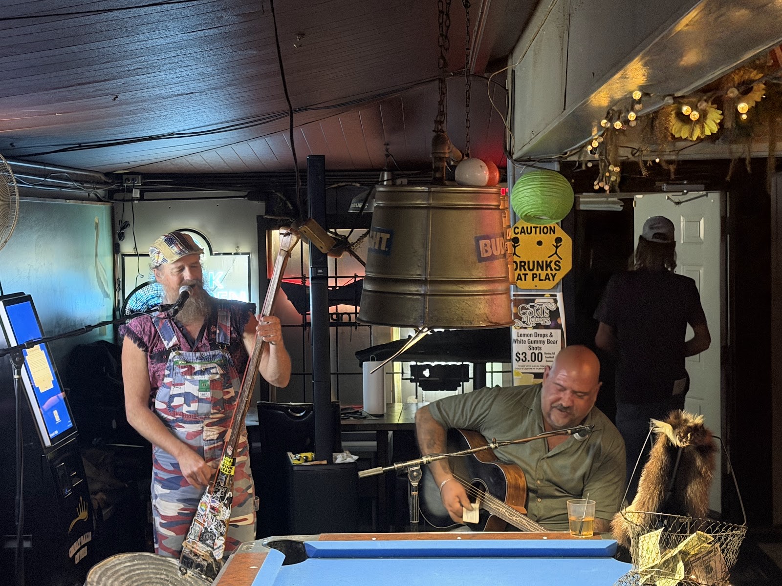 Two musicians playing guitar and singing during a live set inside Hi Way Bar